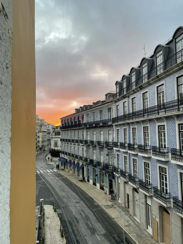 Sunrise view of Lisbon Portugal landmarks from hotel room window